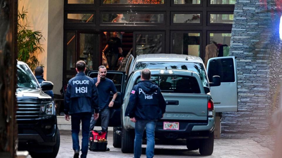 PHOTO: Homeland Security Investigation agents are seen at the entrance of US producer and musician Sean 'Diddy' Combs's home at Star Island in Miami Beach on March 25, 2024. (Giorgio Viera/AFP via Getty Images)