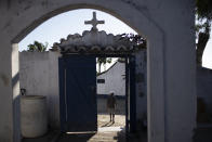 Eduardo Oliveira Costa leaves the Sant'Anna cemetery, where his mother Carivaldina Oliveira da Costa, also known as Aunt Uia, who died from COVID-19 related complications, was buried, in Buzios, Brazil, Sunday, July 12, 2020. Aunt Uia was the grandchild of a former slave and leader of runaway slaves. Brazil was the last country in the Western Hemisphere to abolish slavery, in 1888. (AP Photo/Silvia Izquierdo)