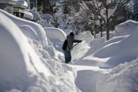 A resident shovels snow away from the entrance to his home in Union City, New Jersey, across the Hudson River from Midtown Manhattan, after the second-biggest winter storm in New York history, January 24, 2016. REUTERS/Rickey Rogers