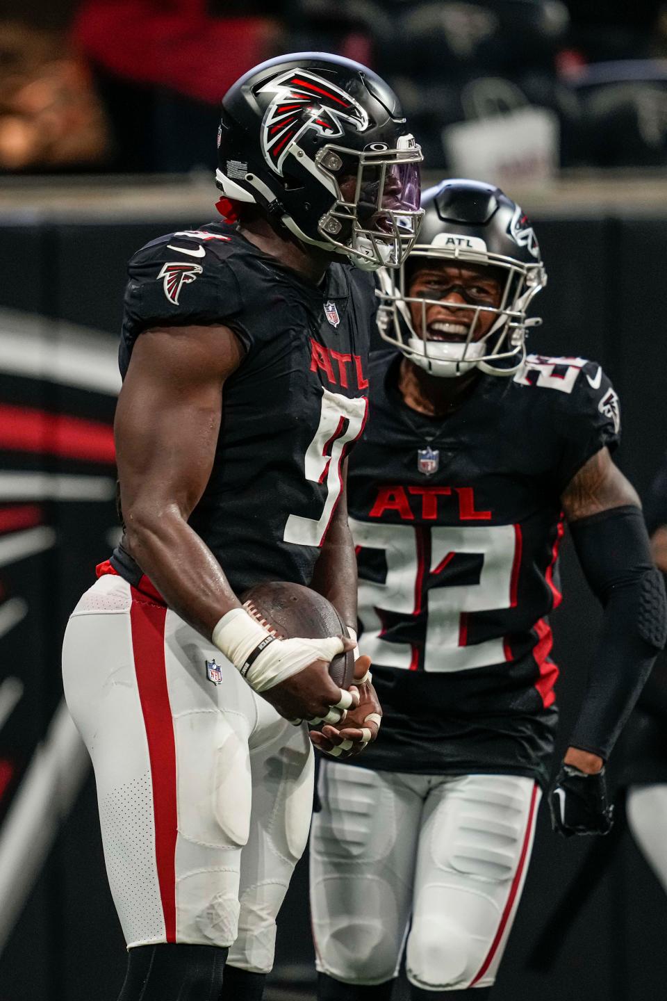 Atlanta Falcons linebacker Lorenzo Carter (9) reacts with cornerback Cornell Armstrong (22) after returning an interception for a touchdown against the Carolina Panthers during the first half at Mercedes-Benz Stadium.