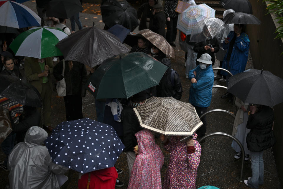 Sydney CBD shoppers shelter from wild weather, heavy rain under umbrellas, Sydney. 