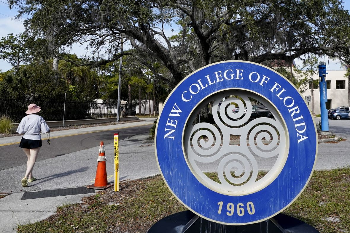 A student makes her way past the sign at New College Friday, Jan. 20, 2023, in Sarasota, Fla. Your education. Your way. Be original. Be you. That’s how New College of Florida describes its approach to higher education in an admission brochure. The state school of fewer than 1,000 students nestled along Sarasota Bay has long been known for its progressive thought and creative course offerings that don’t use traditional grades. The school founded in 1960 is also a haven for marginalized students, especially from the LBGTQ community, said second-year student Sam Sharf in a recent interview. (AP Photo/Chris O’Meara)