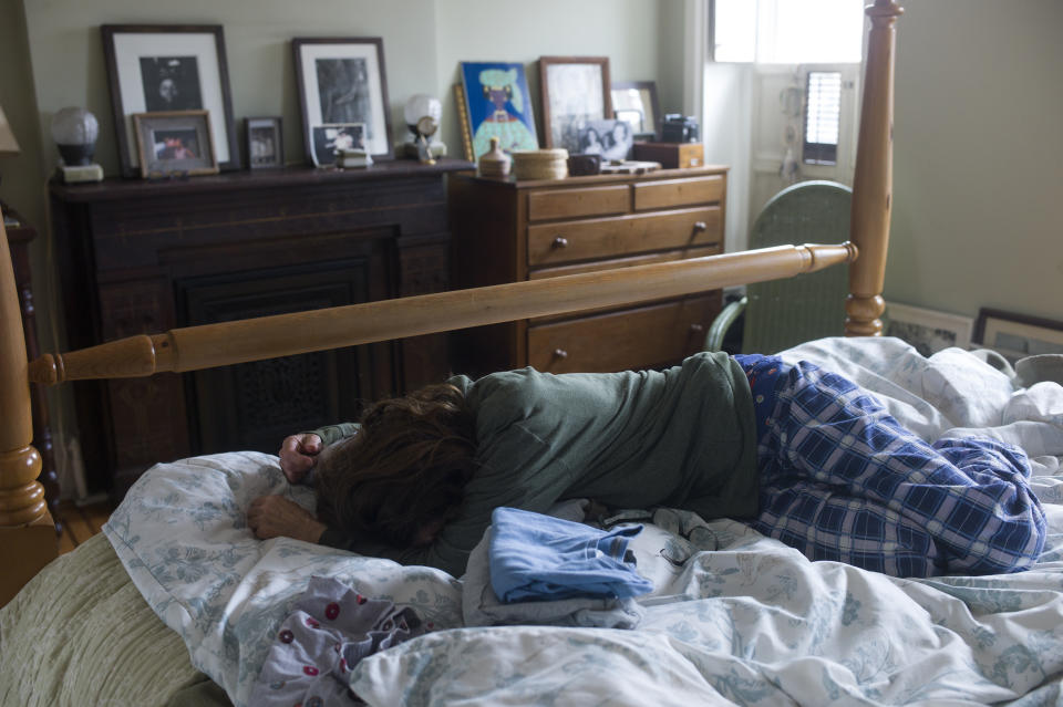 BROOKLYN, NY - MARCH 17: A mother tries to get out of bed in the morning after continuous news of a pandemic, isolation at home, and school being cancelled for her two children, on March 17, 2020 in Brooklyn, New York. (Photo by Andrew Lichtenstein/Corbis via Getty Images)