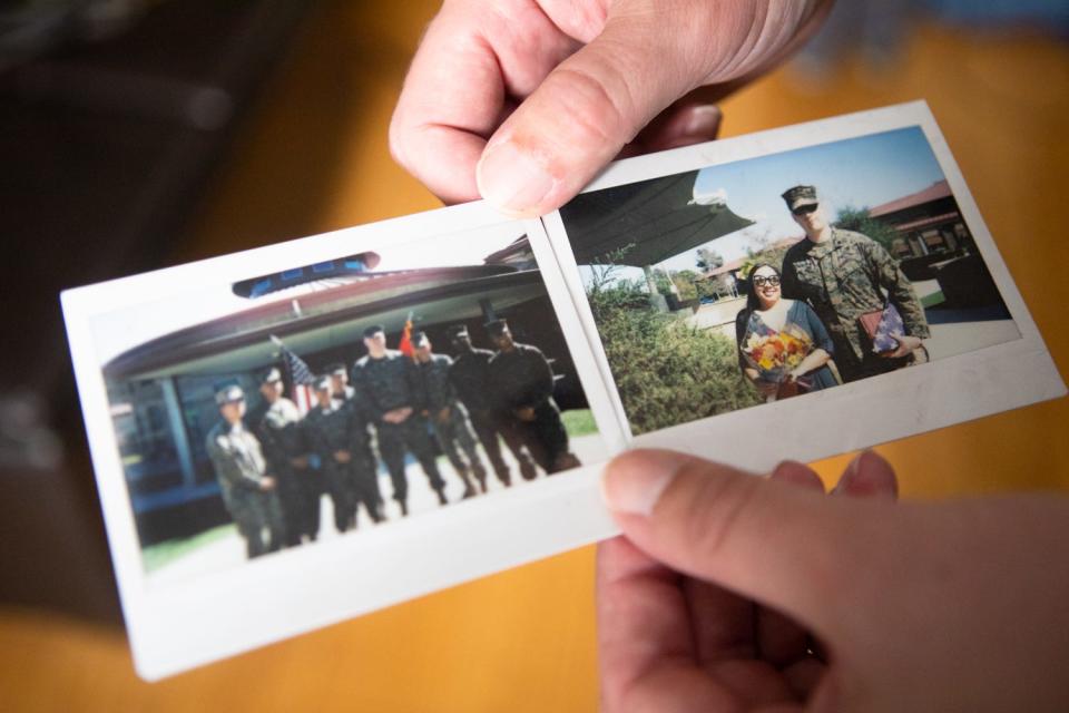 Kiowa Wolfe holds photos from his retirement ceremony, Aug. 5, 2021.