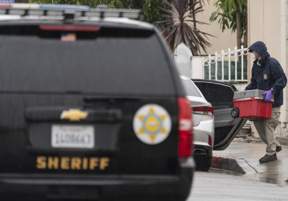 An investigator loads a tool box outside the First Works Baptist Church after an explosion in El Monte, Calif., Saturday, Jan. 23, 2021. The FBI and local police are investigating an explosion early Saturday at the Los Angeles-area church that had been the target of protests for its anti-LGTBQ message. (AP Photo/Damian Dovarganes)