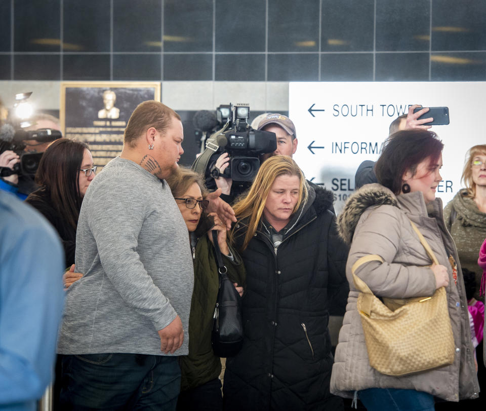 Several members of James Alan Neal's family leave El Paso County's Terry R. Harris Judicial Complex on Thursday, Feb. 21, 2019 in Colorado Springs, Colo. Neal, 72, was arrested Tuesday, Feb. 19, 2019, in Colorado Springs, Colo., and charged with murder with special circumstances in the death of Linda O'Keefe, who was found strangled in 1973, a case that has long shaken the seaside community of Newport Beach, Calif., Orange County District Attorney Todd Spitzer said. (Dougal Brownlie/The Gazette via AP)