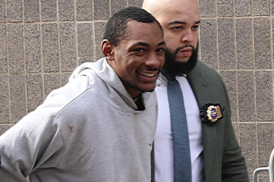 Carlton McPherson grins during his arrest. G.N.Miller/NYPost