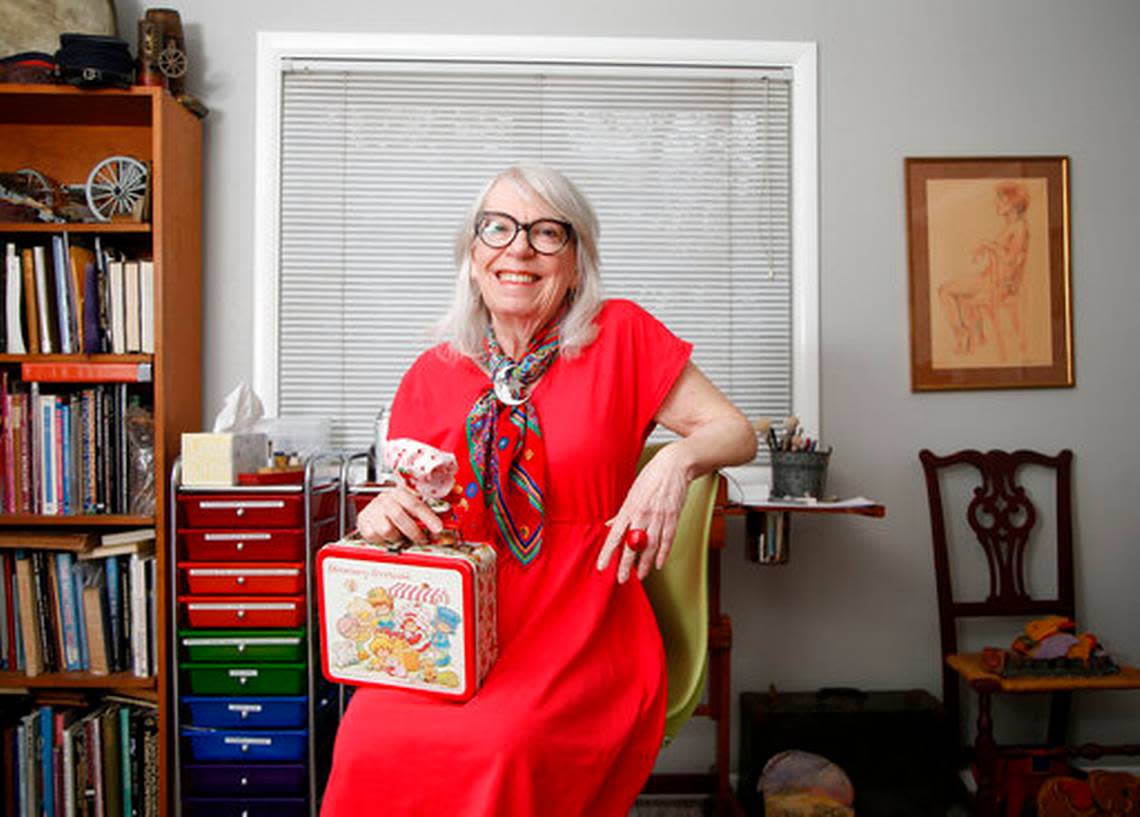 Muriel Fahrion, the creator of the Strawberry Shortake cartoon franchise, sits with a selection of memorabilia at her home studio in Tulsa, Okla., on Monday, March 25, 2019. She will be one of the many comic creators at Lexington ComicCon this weekend.
