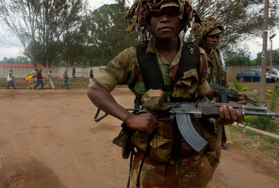 <p>Zimbabwean soldiers patrol as people take part in a demonstration demanding the resignation of Zimbabwe’s president on Nov. 18, 2017 in Harare. (Photo: AFP/Getty Images) </p>