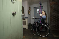 Paralympic archer Kerrie Leonard poses for a phot at her family's farm in Culmullen, Co. Meath, Ireland, Friday, Feb. 19, 2021. Kerrie, who hopes to represent Ireland at the Tokyo games, has been training in the driveway of her home due to the coronavirus pandemic. (Brian Lawless/PA via AP)