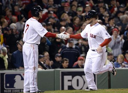 Oct 23, 2013; Boston, MA, USA; Boston Red Sox pinch hitter Daniel Nava (right) is congratulated by shortstop Stephen Drew (not pictured) after scoring a run in the 8th inning against the St. Louis Cardinals during game one of the MLB baseball World Series at Fenway Park. Robert Deutsch-USA TODAY Sports