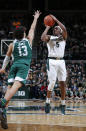 Michigan State's Cassius Winston, right, shoots against Eastern Michigan's Chris James (13) during the second half of an NCAA college basketball game, Saturday, Dec. 21, 2019, in East Lansing, Mich. (AP Photo/Al Goldis)