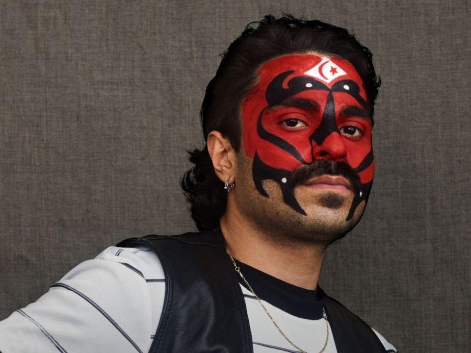 A person with red and black face paint