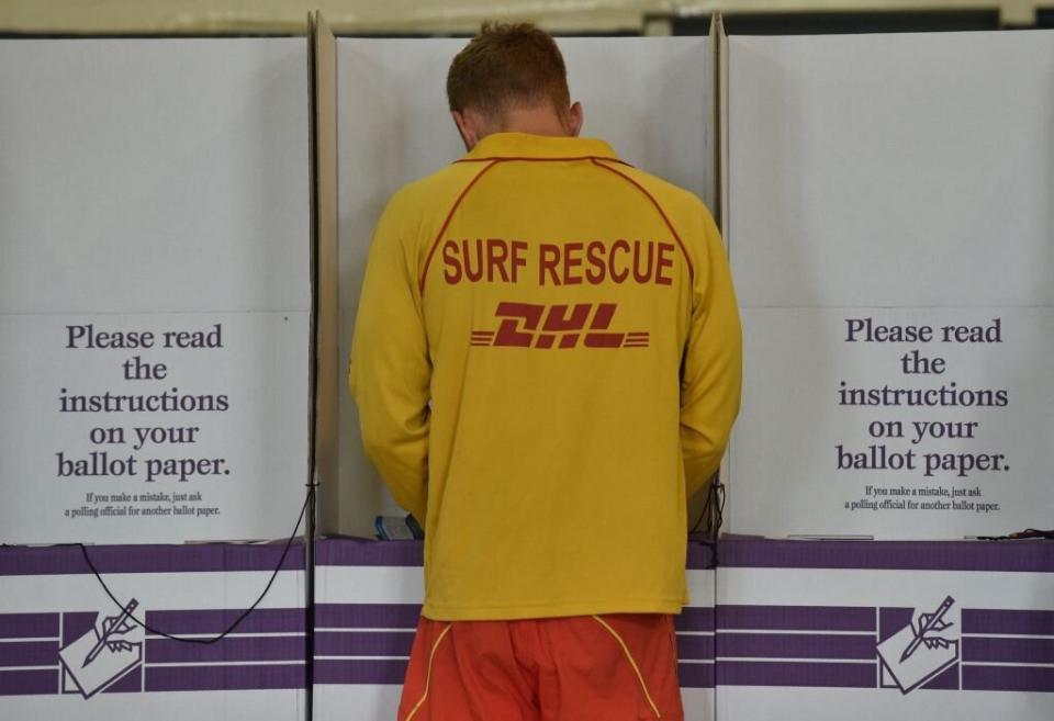 A surf lifesaver votes at a polling booth in the Australian Federal Election 2016. Source: Getty