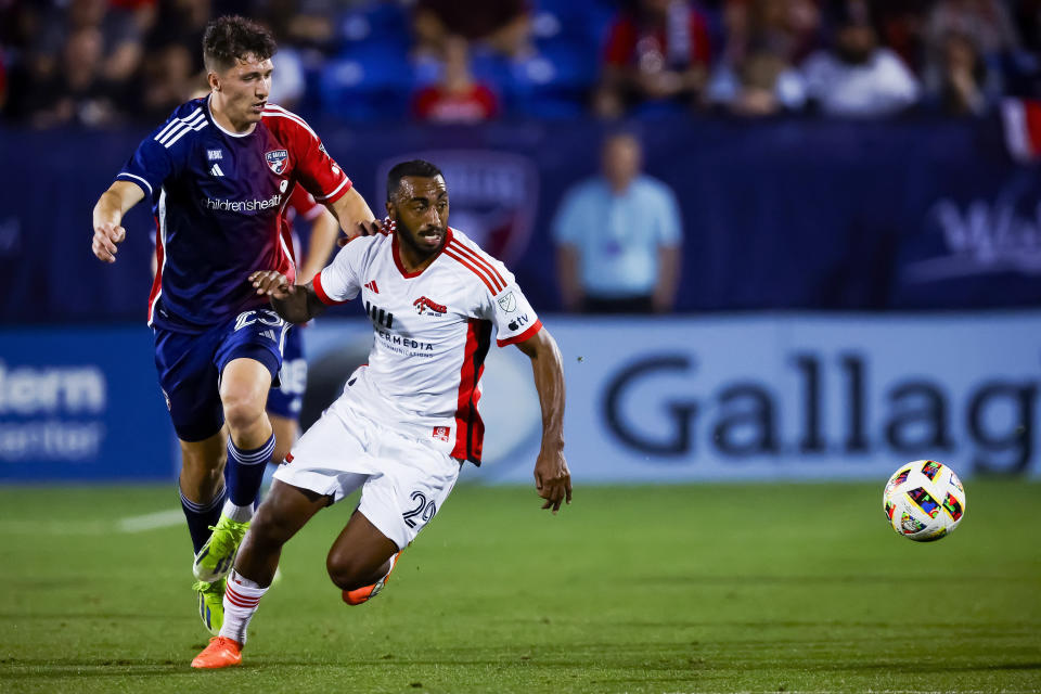 FC Dallas forward Logan Farrington (23) and San Jose Earthquakes defender Carlos Akapo (29) chase the ball during the first half of an MLS soccer match Saturday, Feb. 24, 2024, in Frisco, Texas. (AP Photo/Brandon Wade)