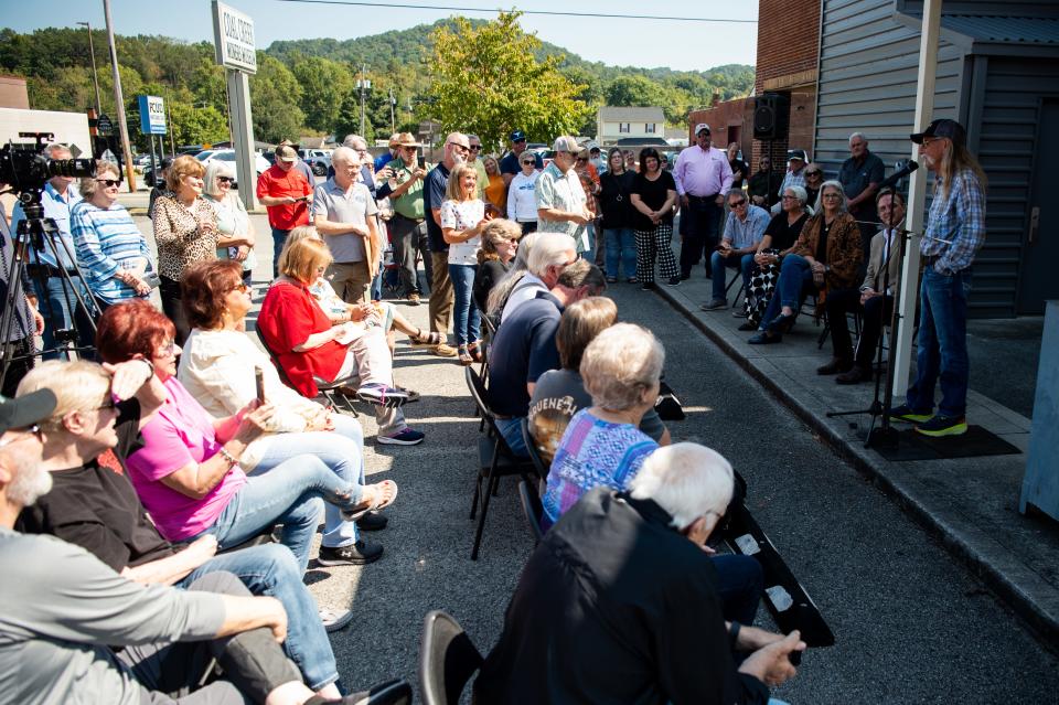 Country music songwriter and performer Dean Dillon speaks next to the Coal Creek Miner Museum in Rocky Top.