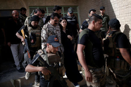 Yazidi survivor and United Nations Goodwill Ambassador for the Dignity of Survivors of Human trafficking Nadia Murad (C) is surrounded by Popular Mobilisation Forces (PMF) fighters in Kojo, Iraq June 1, 2017. REUTERS/Alkis Konstantinidis