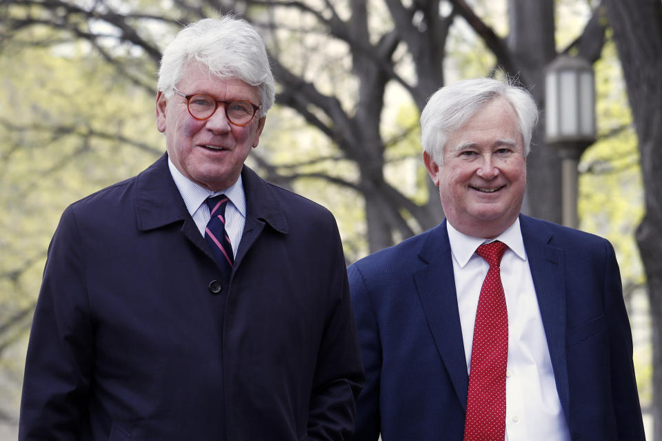 Greg Craig, left, arrives ahead of his arraignment at federal court in Washington on Friday April 12, 2019. (AP Photo/Jacquelyn Martin)