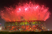 Host nation China put on a spectacular fireworks display over the National Stadium for the 2008 Beijing Summer Olympics Opening Ceremony. Too bad it wasn't all real. Because it was decided it was too dangerous to fly a helicopter to film to spectacle, some of the pyrotechnics were computer generated for Chinese television. (Photo by Stu Forster/Getty Images)