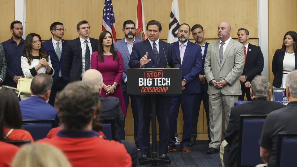 Florida Gov. Ron DeSantis, center, gives his opening remarks flanked by local state delegation members prior to signing legislation that seeks to punish social media platforms that remove conservative ideas from their sites, inside Florida International University's MARC building in Miami on Monday, May 24, 2021. - Carl Juste/Miami Herald/AP