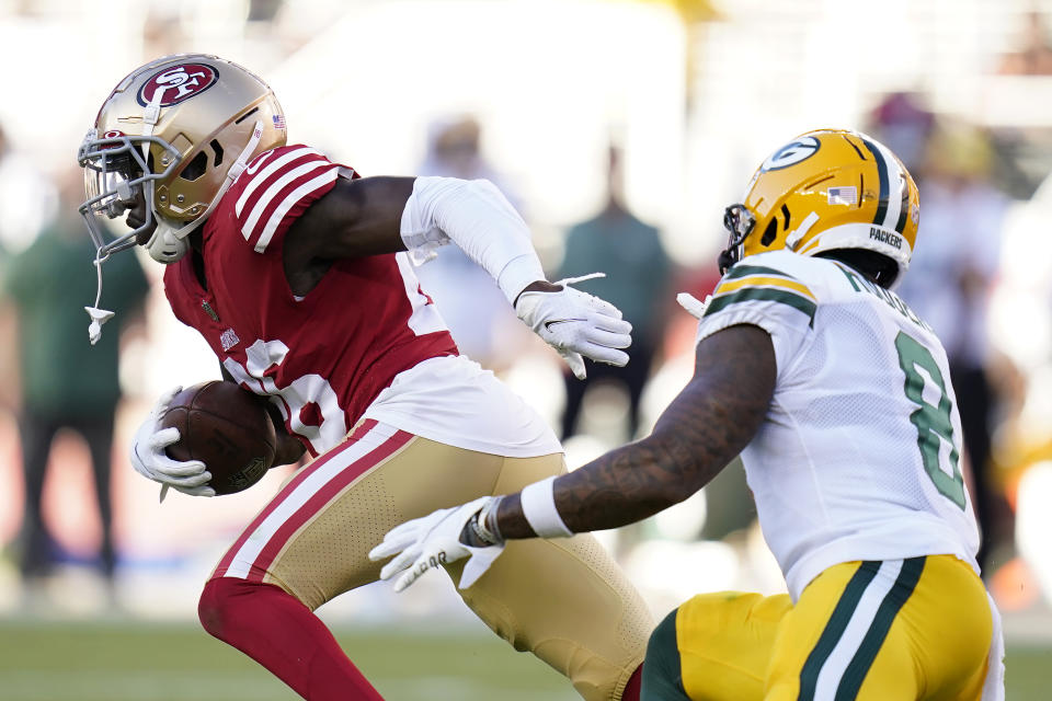 San Francisco 49ers cornerback Samuel Womack III, left, runs after intercepting a pass in front of Green Bay Packers wide receiver Amari Rodgers during the first half of an NFL preseason football game in Santa Clara, Calif., Friday, Aug. 12, 2022. (AP Photo/Godofredo A. Vásquez)