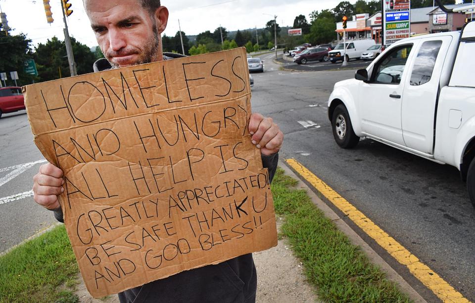 Steve panhandles on a well-worn path at the corner of Route 6 and Father Devalles Boulevard in Fall River on Monday, Sept. 11, 2023.