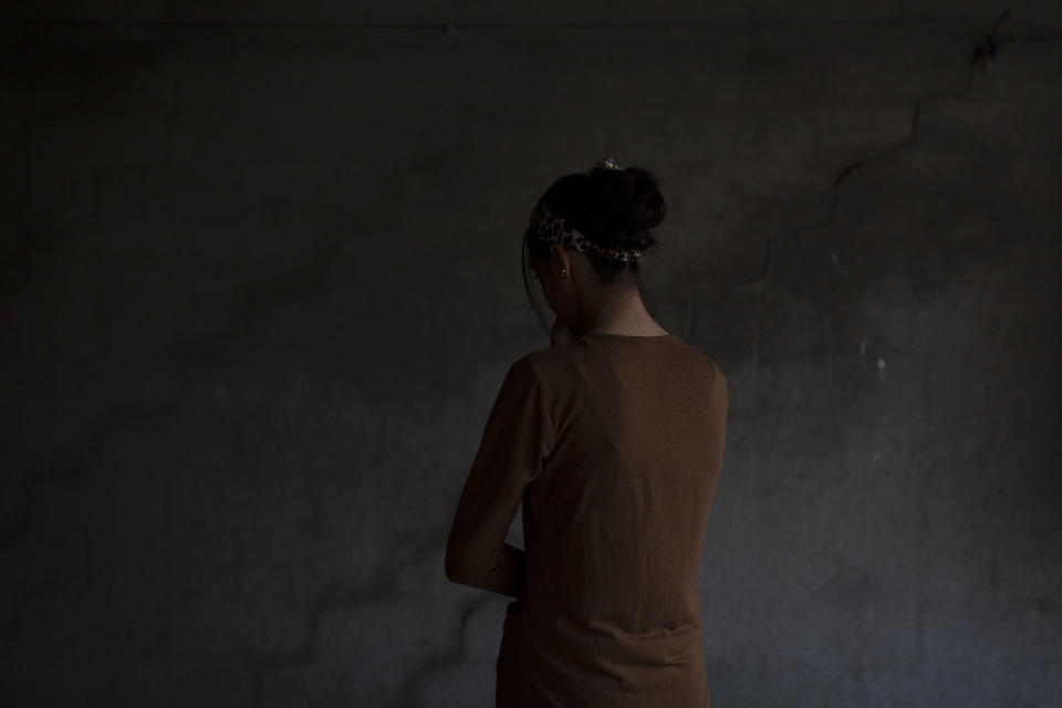 In this Nov. 14, 2019 photo, a Yazidi woman who endured five years of captivity by Islamic State militants poses for a portrait in her home in northern Iraq. "They beat me and sold me and did everything to me," she says. Raped by nearly a dozen owners over years of captivity, she was owned by IS leader Abu Bakr al-Baghdadi for months before he "gifted" her to one of his aides. She was freed in a U.S.-led raid in May, 2019. (AP Photo/Maya Alleruzzo)