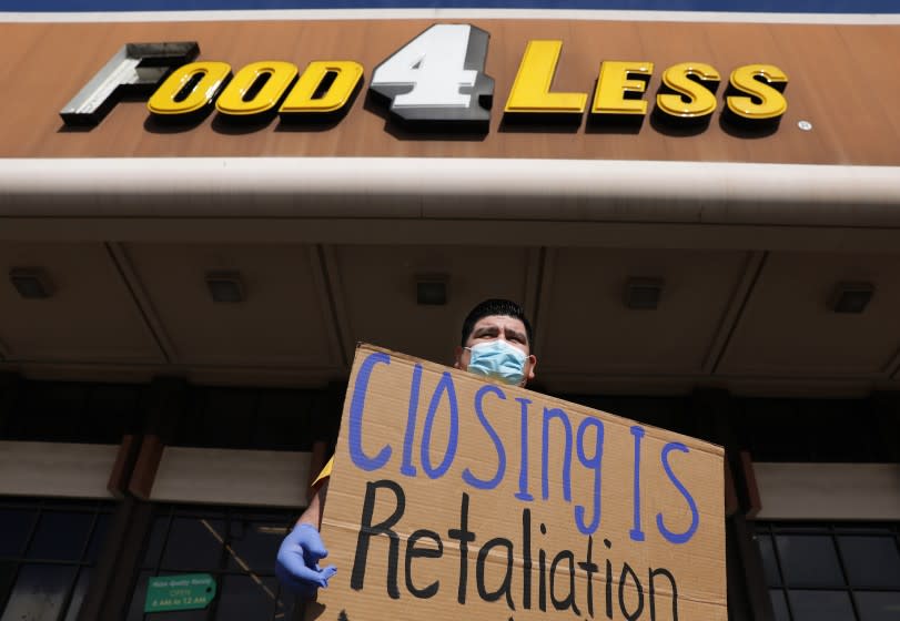 LONG BEACH-CA-FEBRUARY 3, 2021: Jose Rocha, a union member, holds a sign in support for Food 4 Less workers at the grocery store on South Street in North Long Beach on Wednesday, February 3, 2021. Food 4 Less workers, city leaders and local labor advocates hold a news conference to call on Kroger Co., the parent company of Food 4 Less and Ralph's, to keep stores open and condemn the company's actions to close two of its locations in the city because of the city's emergency ordinance for $4 per hour in temporary hazard pay. (Christina House / Los Angeles Times)