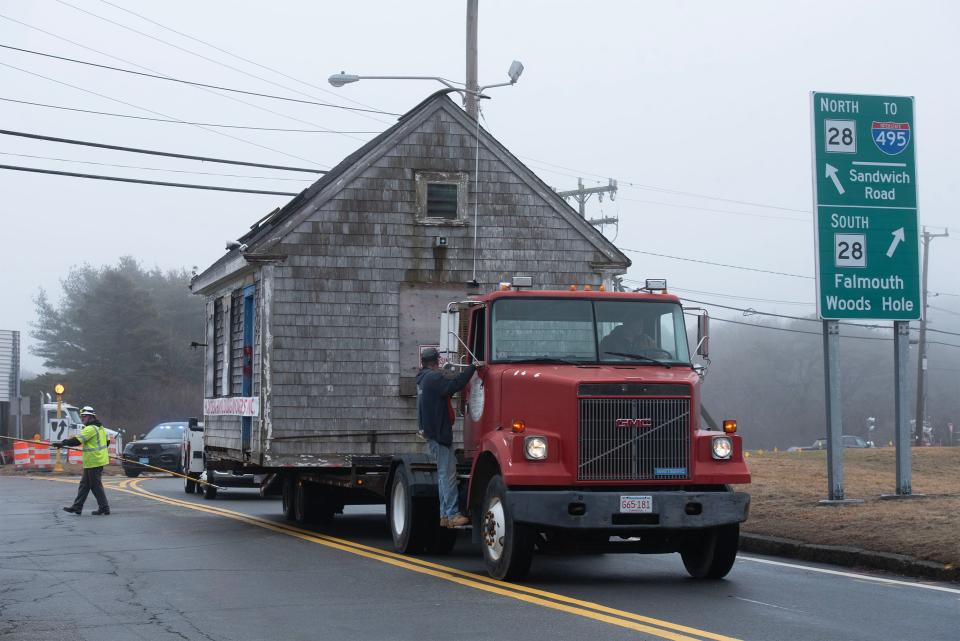 Hayden Building movers truck driver Mark Barros slowly heads down Trowbridge Road in Bourne on Wednesday as the old tourist information booth moved from its location just off the Bourne Rotary to a new home at the Aptuxcet VFW on Shore Road.