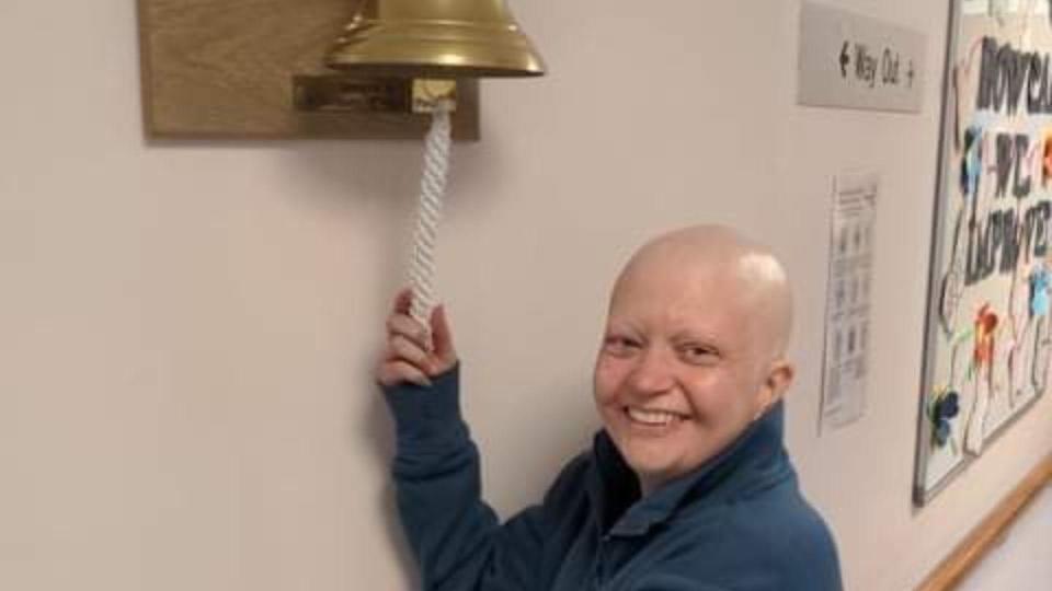 Michelle celebrating her remission from cancer by ringing the bell. (Photo: Michelle Collins)
