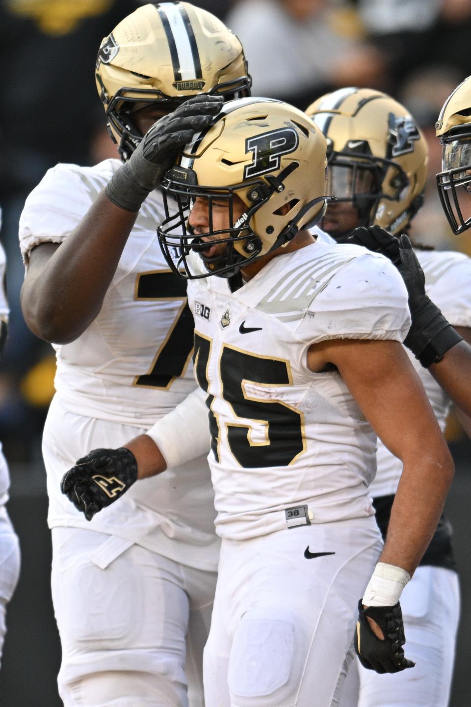 Oct 7, 2023; Iowa City, Iowa, USA; Purdue Boilermakers running back Devin Mockobee (45) reacts with offensive lineman Mahamane Moussa (77) after scoring a touchdown against the Iowa Hawkeyes during the fourth quarter at Kinnick Stadium. Mandatory Credit: Jeffrey Becker-USA TODAY Sports