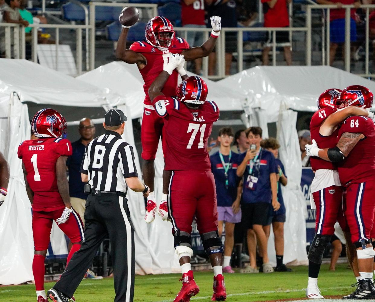 Florida Atlantic wide receiver Tony Johnson (0) celebrates a touchdown pass during a 42-20 victory over Monmouth in September. Johnson is now a UC Bearcat.