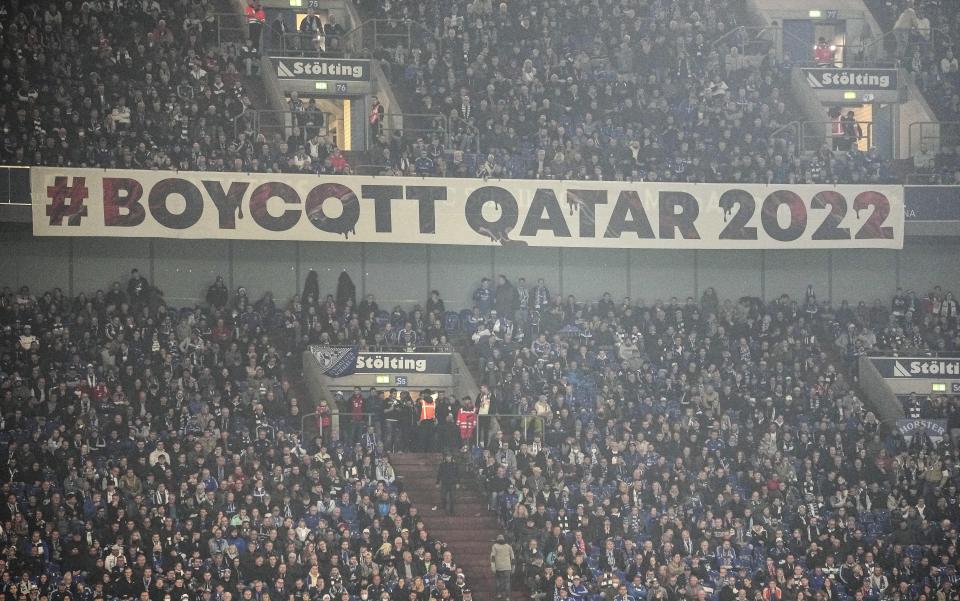 A banner reads "boycott Qatar 2022" on the tribune during the German Bundesliga soccer match between FC Schalke 04 and Bayern Munich in Gelsenkirchen, Germany, Saturday, Nov. 12, 2022. (AP Photo/Martin Meissner)