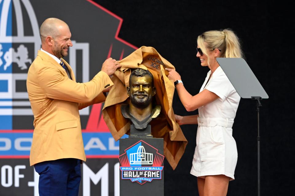 Joe Thomas, left, and his wife Annie unveil his bust during the Pro Football Hall of Fame Enshrinement, Saturday, Aug. 5, 2023, in Canton.