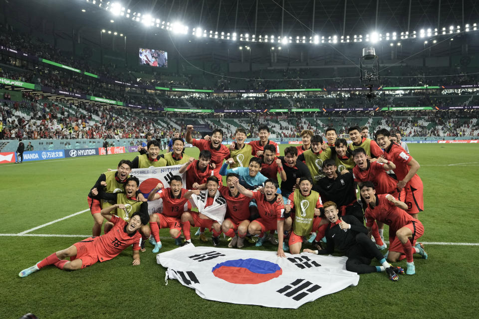 South Korea's players celebrate at the end of the World Cup group H soccer match between South Korea and Portugal, at the Education City Stadium in Al Rayyan , Qatar, Friday, Dec. 2, 2022. (AP Photo/Hassan Ammar)