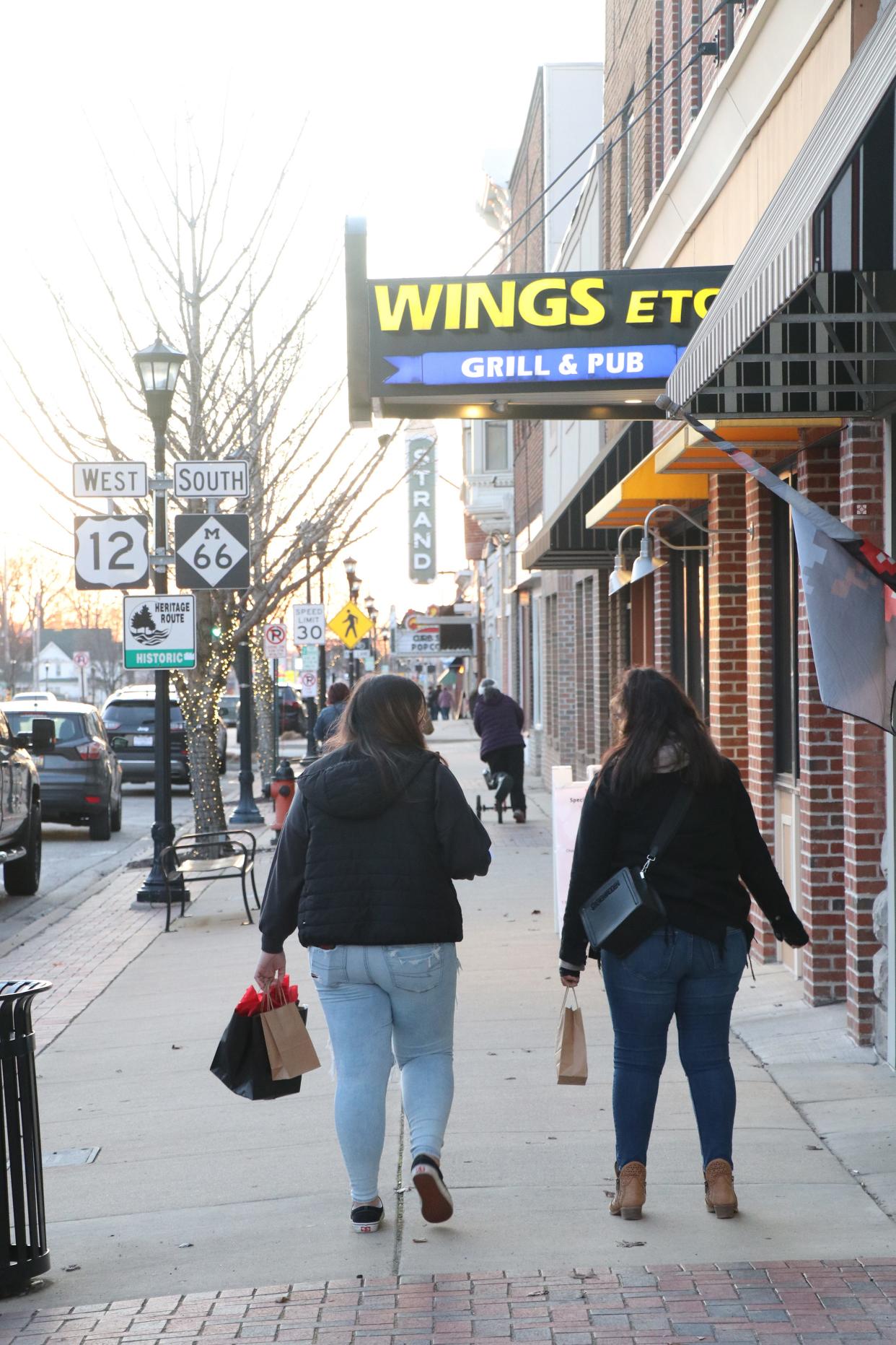 Participants in the Ladies Night Out event in downtown Sturgis walk between businesses Feb. 10, 2023.