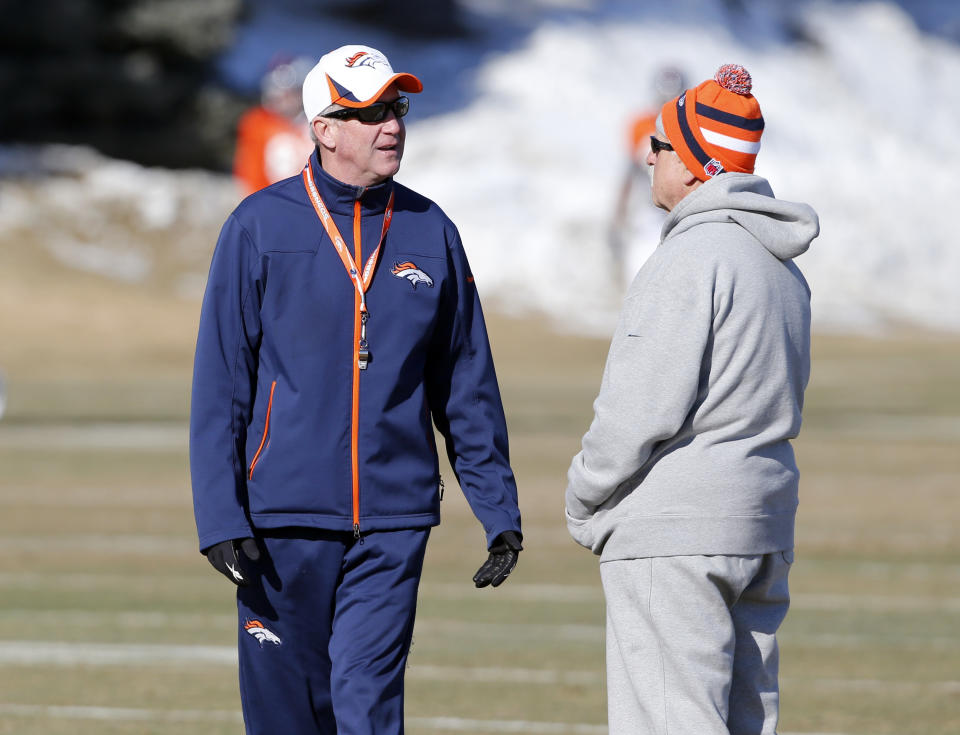 Denver Broncos head coach John Fox, left, talks with offensive consultant Alex Gibbs at practice for the football team's NFL playoff game against the San Diego Chargers at the Broncos training facility in Englewood, Colo., on Wednesday, Jan. 8, 2014. (AP Photo/Ed Andrieski)