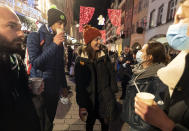 FILE - In this Dec. 17, 2020 file photo, people enjoy a glass of mulled wine in the street before the curfew in Strasbourg, eastern France. Trying to fend off the need for a third nationwide lockdown that would further dent Europe’s second-largest economy and put more jobs in danger, France is instead opting for creeping curfews. (AP Photo/Jean-Francois Badias, File)