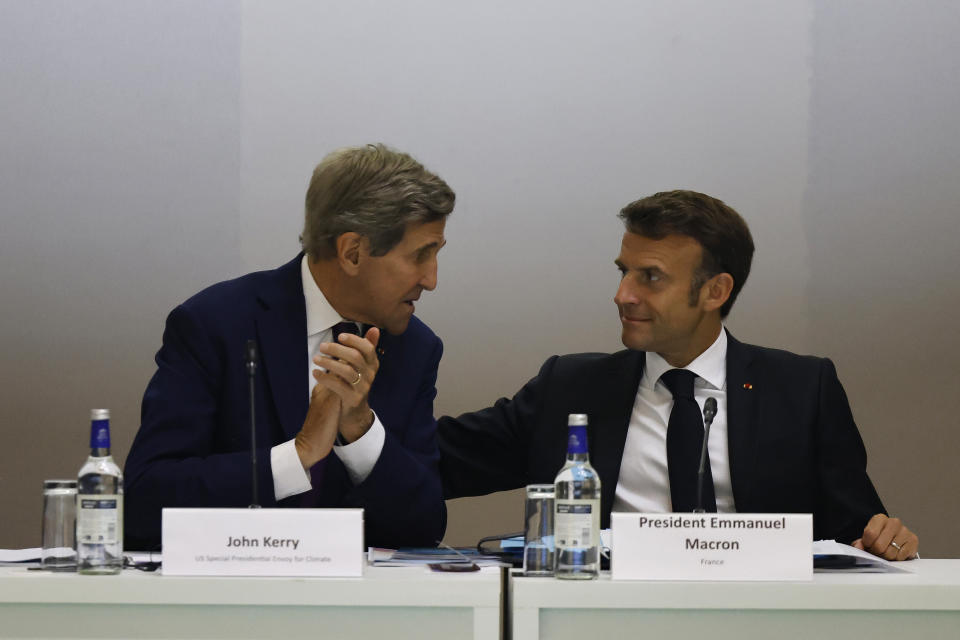 US Climate Envoy John Kerry, left, and French President Emmanuel Macron talk as they take part in the CEO round table discussion at the New Global Financial summit in Paris Thursday, June 22, 2023. World leaders, heads of international organizations and activists are gathering in Paris for a two-day summit aimed at seeking better responses to tackle poverty and climate change issues by reshaping the global financial system. (Ludovic Marin, Pool via AP)