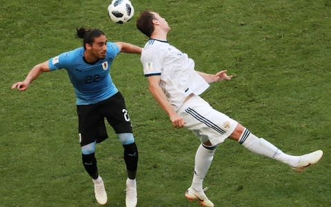 Uruguay's Martin Caceres (L) and Russia's Artyom Dzyuba in action in their 2018 FIFA World Cup Group A football match at Samara Arena Stadium - Credit: Getty Images