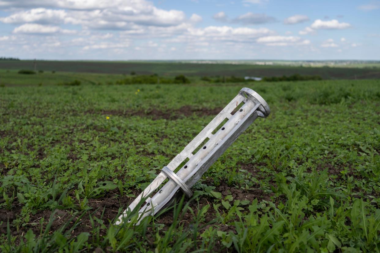 The remains of a cluster-type munition lie in a field in Cherkaska Lozova, outskirts of Kharkiv, eastern Ukraine, on Saturday. (AP Photo/Bernat Armangue)