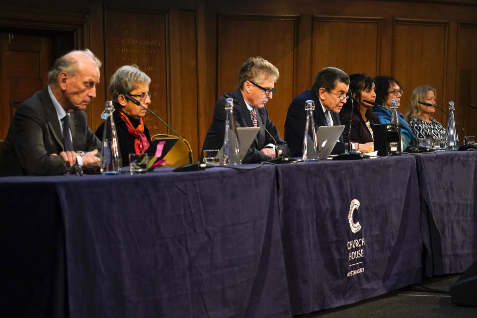 Tribunal chair Geoffrey Nice, fourth left, delivers the verdict of the independent tribunal assessing evidence on China’s alleged rights abuses against the Uyghur people, in London, Thursday, Dec. 9, 2021. The independent and unofficial body set up by a prominent British barrister has concluded that the Chinese government committed genocide and crimes against humanity. (AP Photo/Alberto Pezzali)