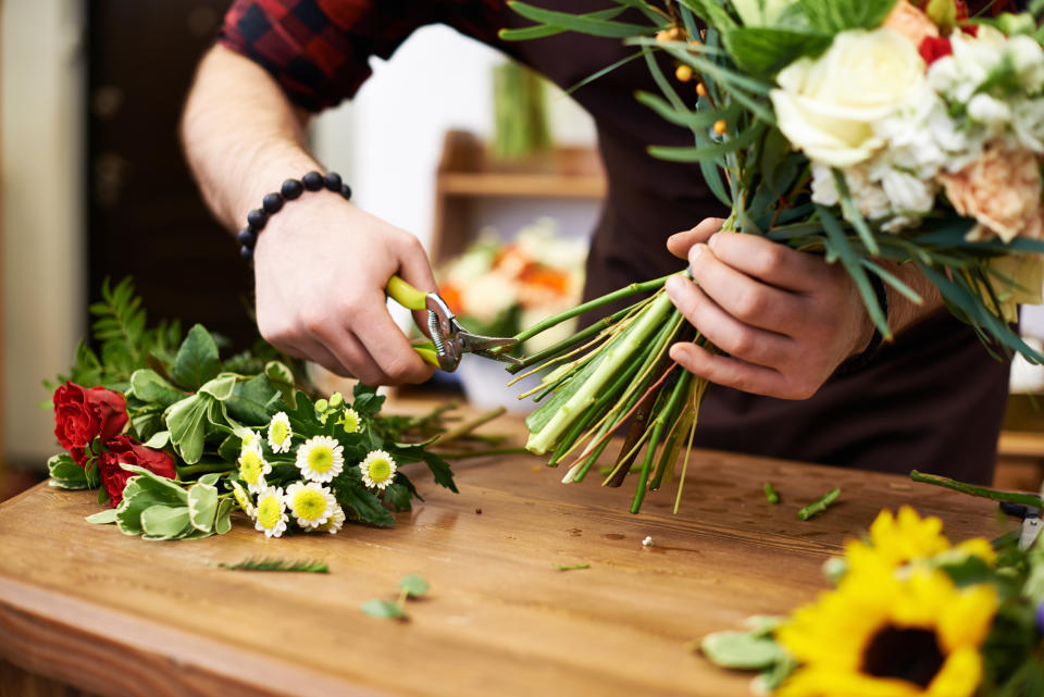 Floral designer cutting flower stems