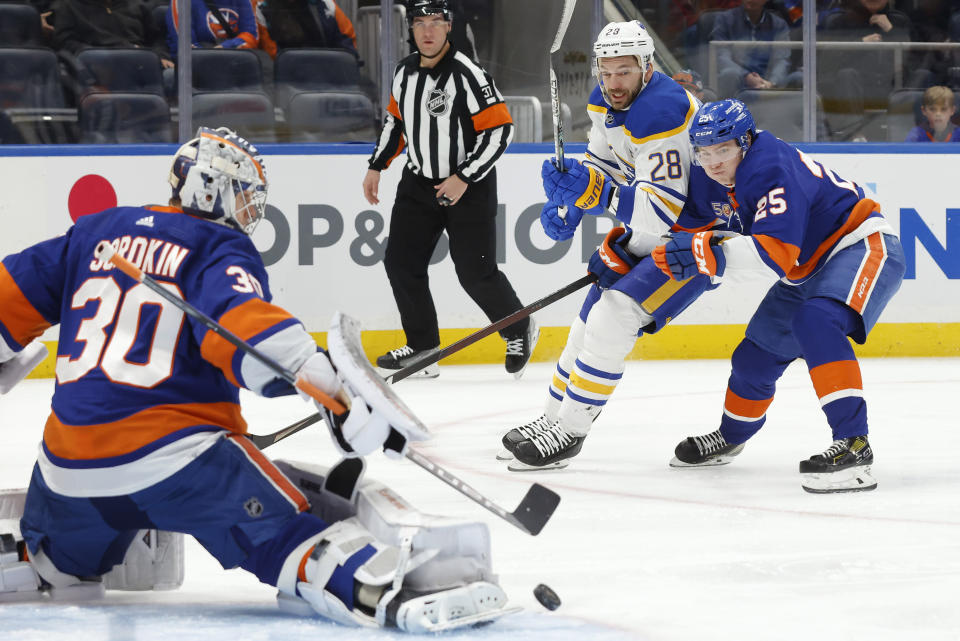 Buffalo Sabres' Zemgus Girgensons (28) is defended by New York Islanders' Sebastian Aho (25) as his shot is saved by New York Islanders goalie Ilya Sorokin (30) during the first period of an NHL hockey game Tuesday, March 7, 2023, in Elmont, N.Y. (AP Photo/Jason DeCrow)