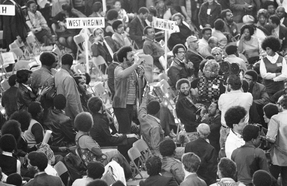 FILE - In this March 13, 1972, file photo, the Rev. Jesse Jackson, executive director of Operation: PUSH, speaks from the floor of the National Black Political Convention in Gary, Ind. Thousands of Black activists from across the U.S. will hold the 2020 Black National Convention on Aug. 28, 2020, via livestream to produce a new political agenda that builds on the protests that followed George Floyd’s death. Convention organizers said this year’s event will pay tribute to the historic 1972 National Black Political Convention. (AP Photo/Jim Wells, File)