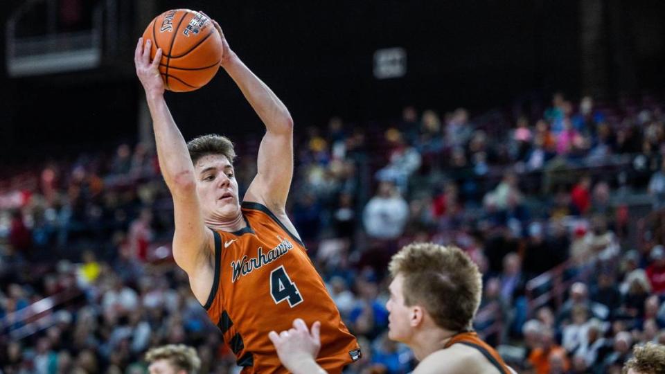 Ridgevue junior Dawson Phillips grabs a rebound against Pocatello in the 4A boys basketball state semifinals March 1 at the Ford Idaho Center in Nampa.