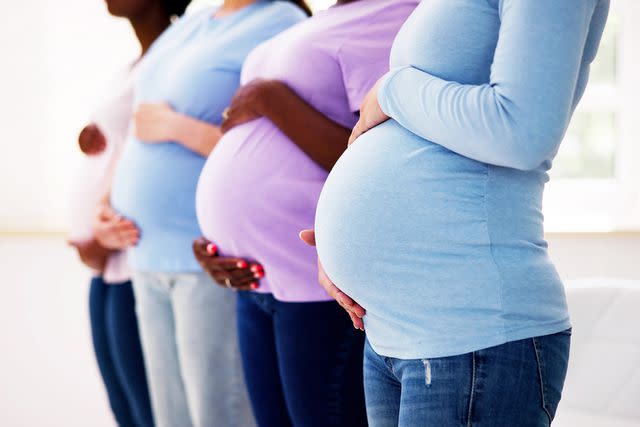 <p>Andrey Popov/Getty</p> Stock photo of a group of pregnant women