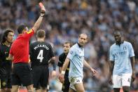 Manchester City's Pablo Zabaleta (right) is sent off by referee Andre Marriner, for a second bookeable offence, following a challenge on Wigan Athletic's Callum McManaman