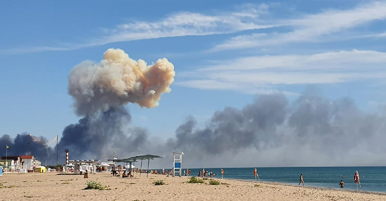 FILE - Rising smoke can be seen from the beach at Saky after explosions were heard from the direction of a Russian military airbase near Novofedorivka, Crimea, Aug. 9, 2022. More massive explosions and fires hit a military depot in Russia-annexed Crimea on Tuesday, Aug. 16, 2022, forcing the evacuation of more than 3,000 people, the second time in recent days that the Ukraine war’s focus has turned to the contested peninsula. (UGC via AP, File)