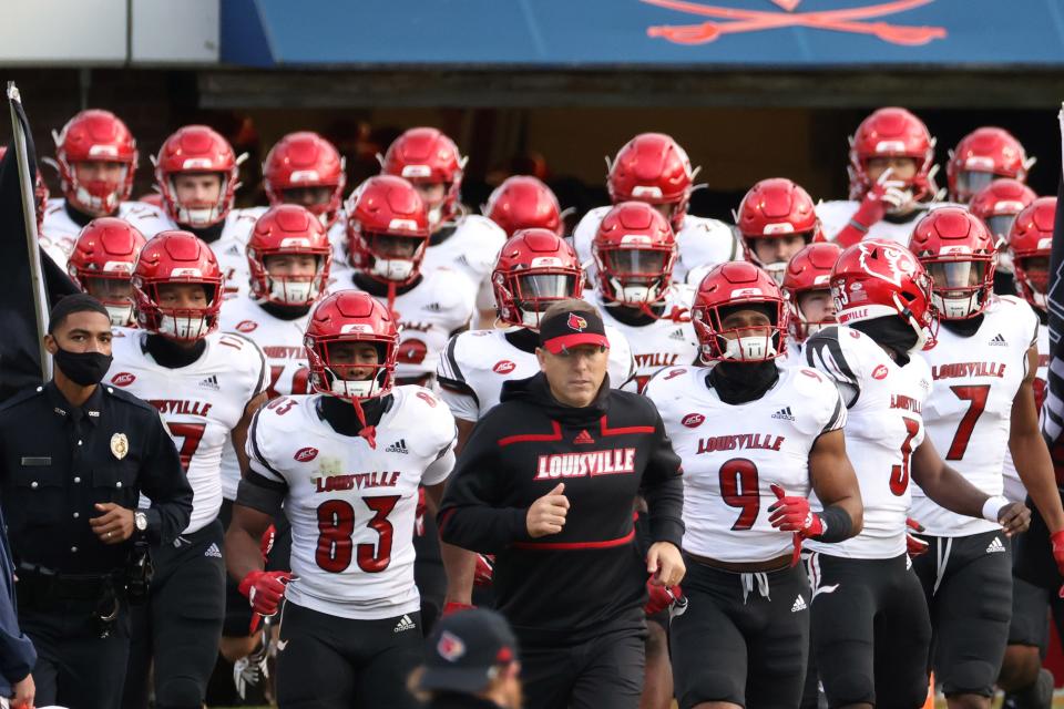 Louisville head coach Scott Satterfield, middle, and his Cardinals have a pretty challenging schedule in 2021.